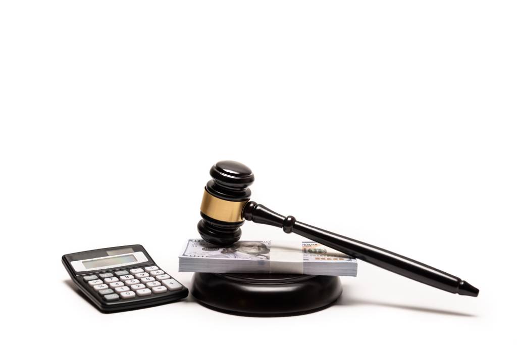 Gavel near calculator with stack of money