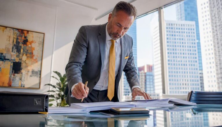Attorney reviewing legal documents at desk