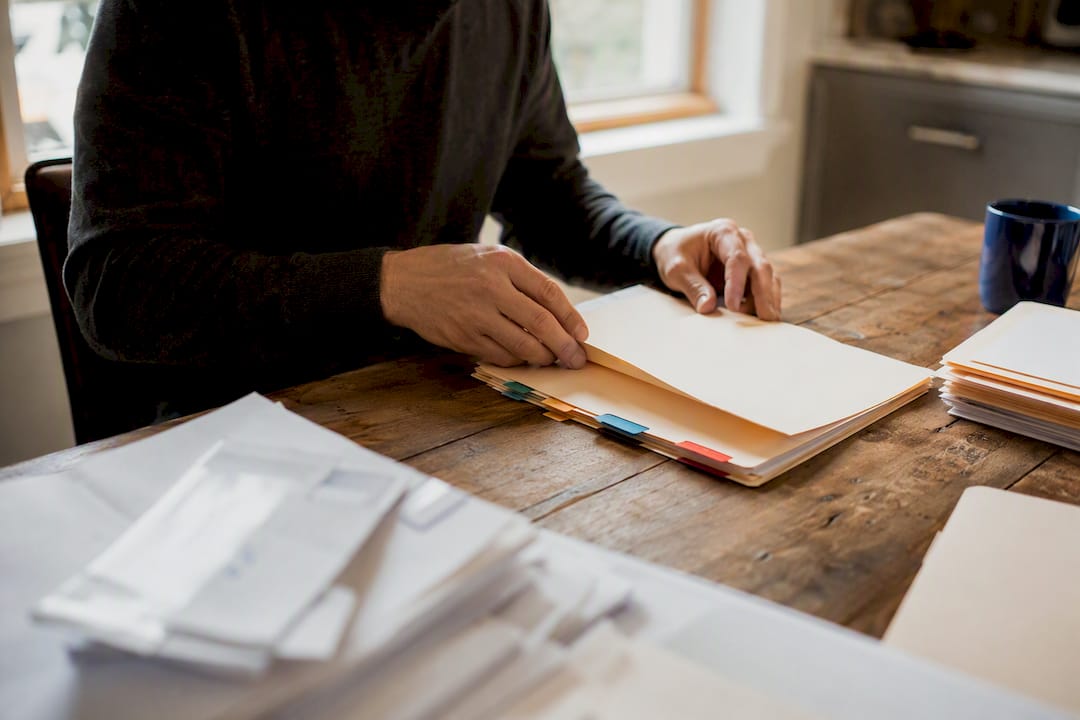 Hands sorting medical lien documents