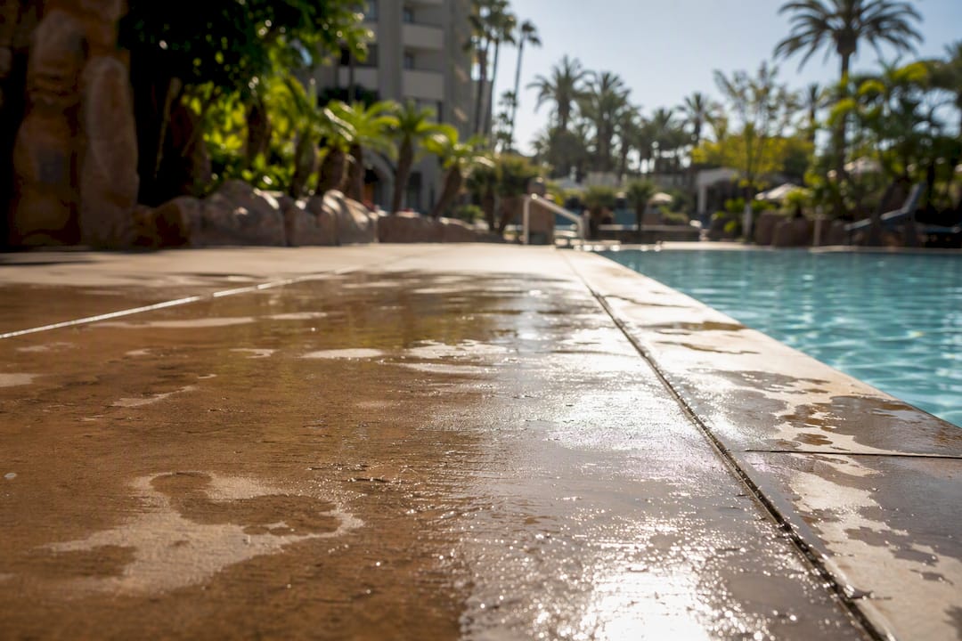Wet hotel pool deck floor hazard close-up