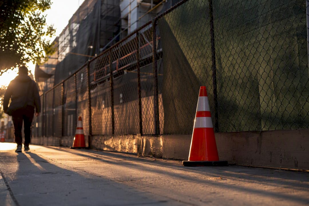 Construction site debris hazard near pedestrian