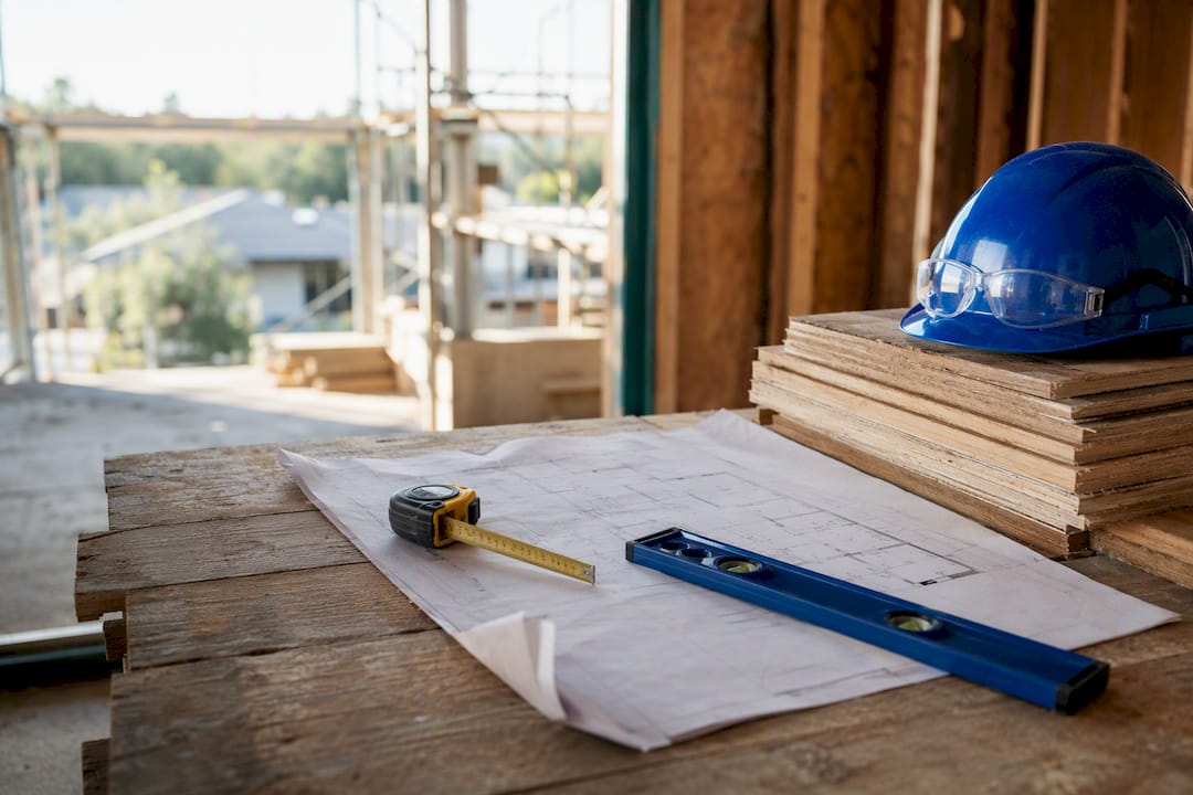 Blueprints and tools on construction site surface